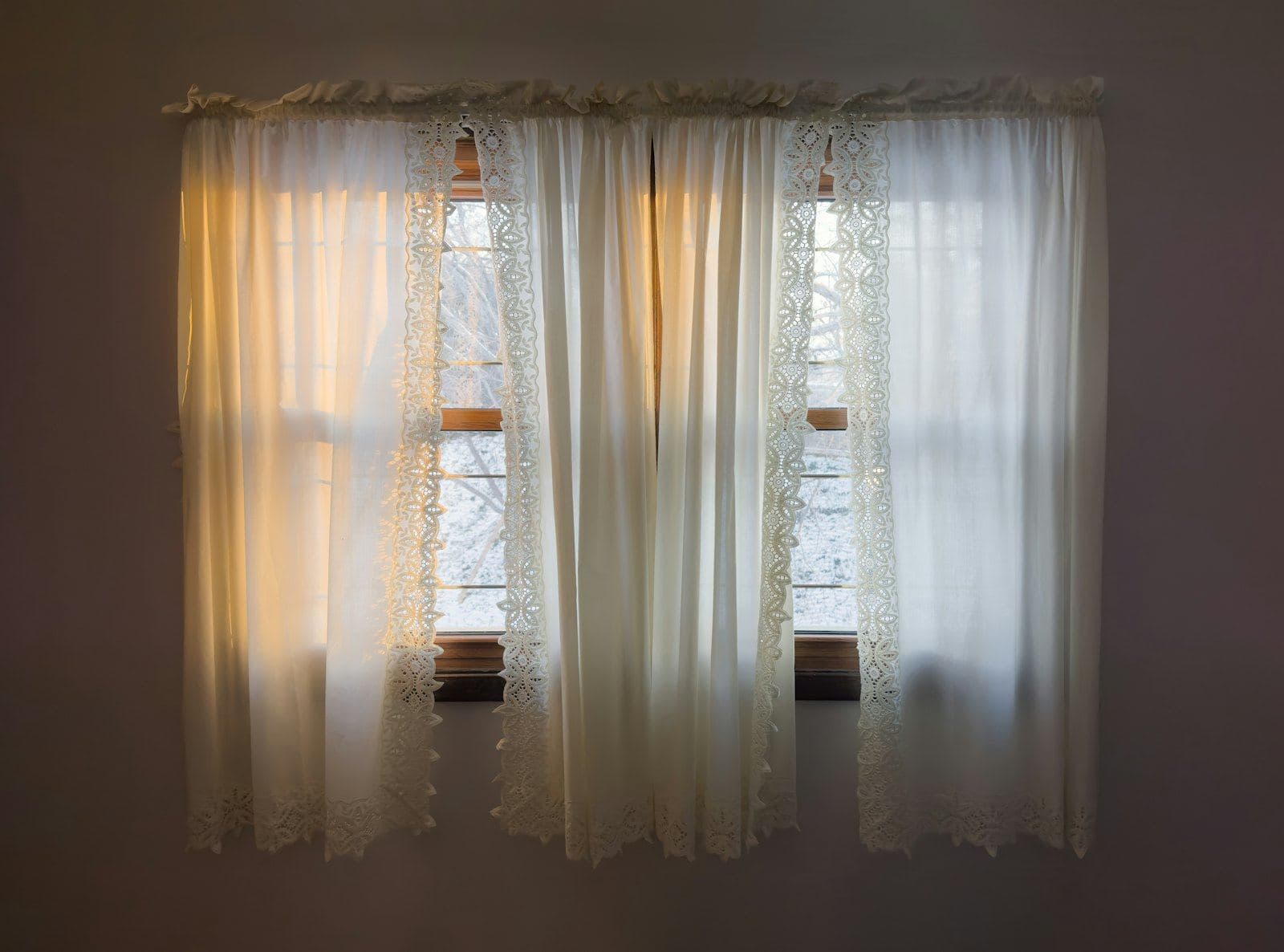 Morning light coming through white curtains