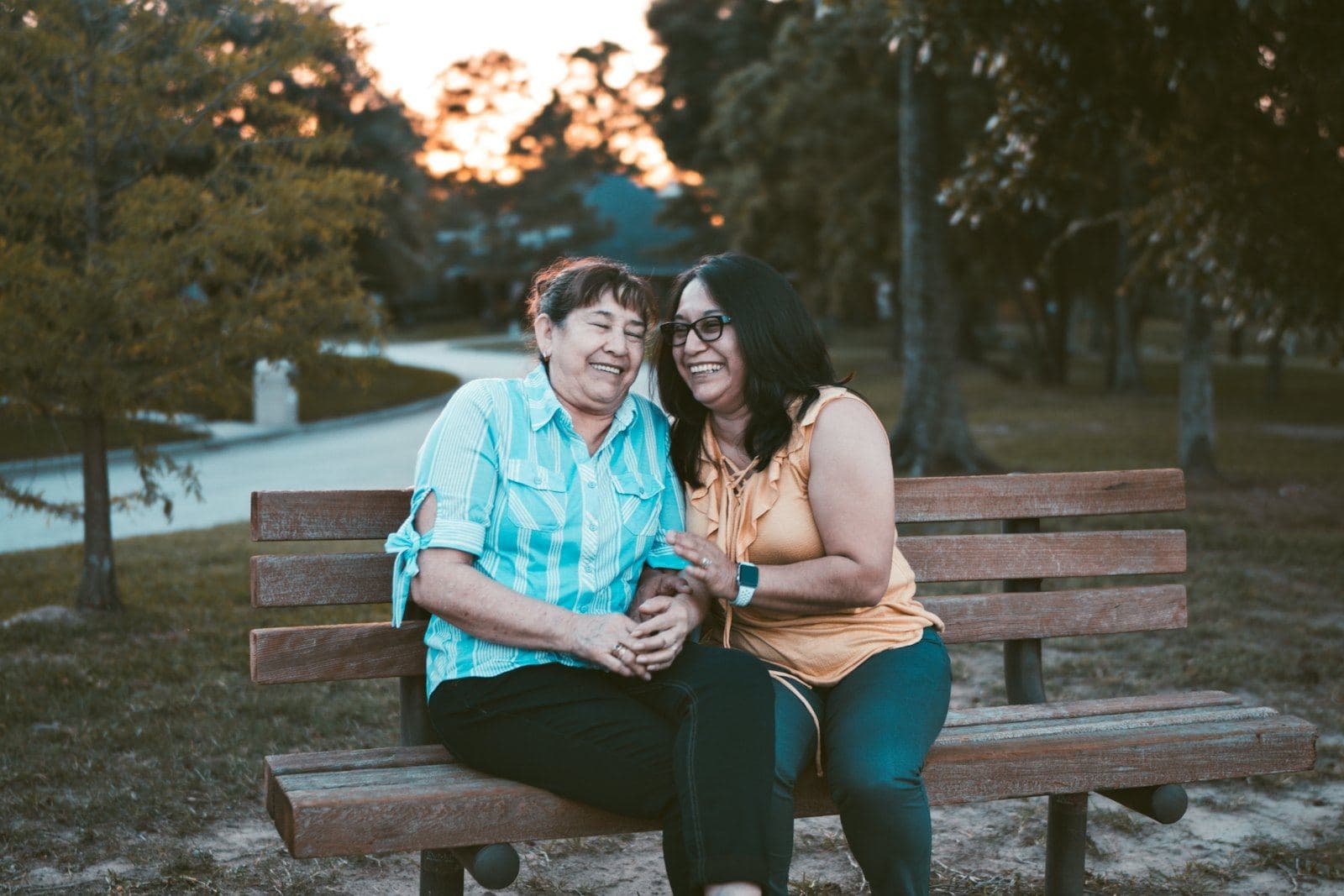 Two women talking together on a park bench