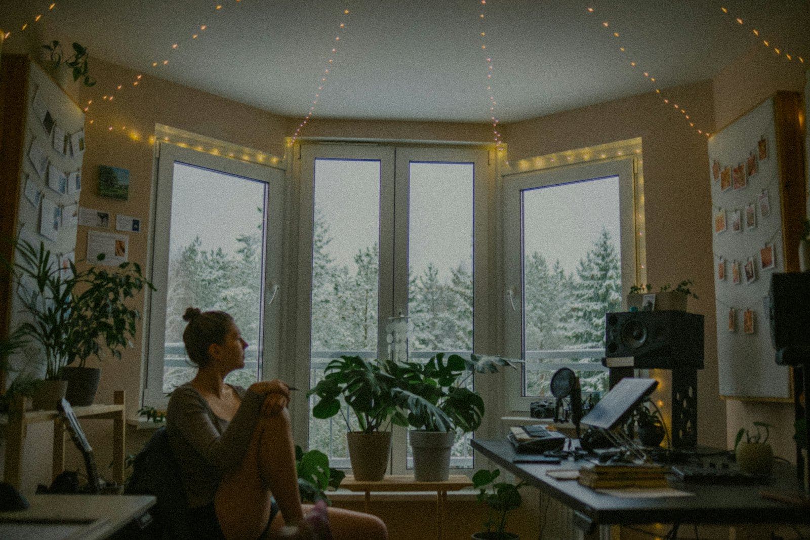 A woman sitting quietly in a softly lit room