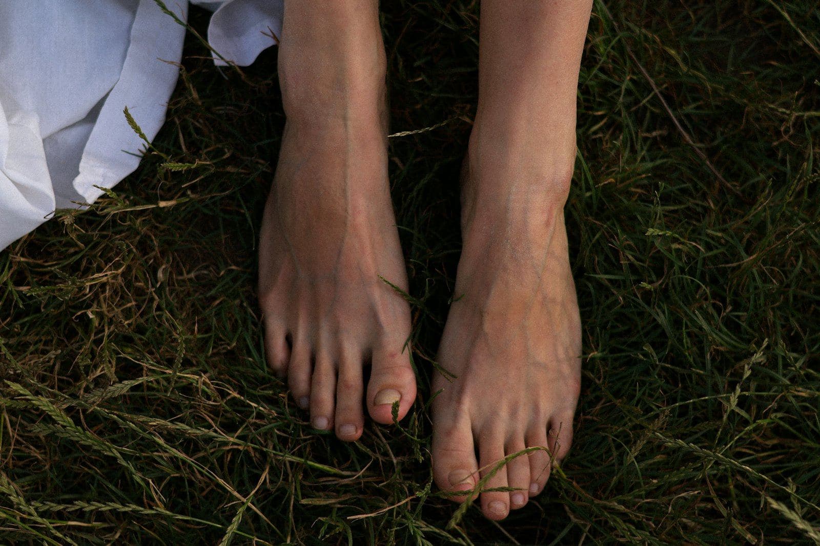Bare feet resting on the grass
