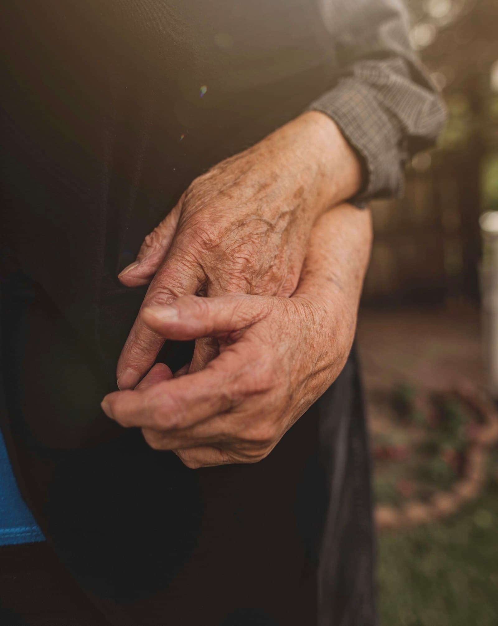 Close-up of an older person's hands clasped together