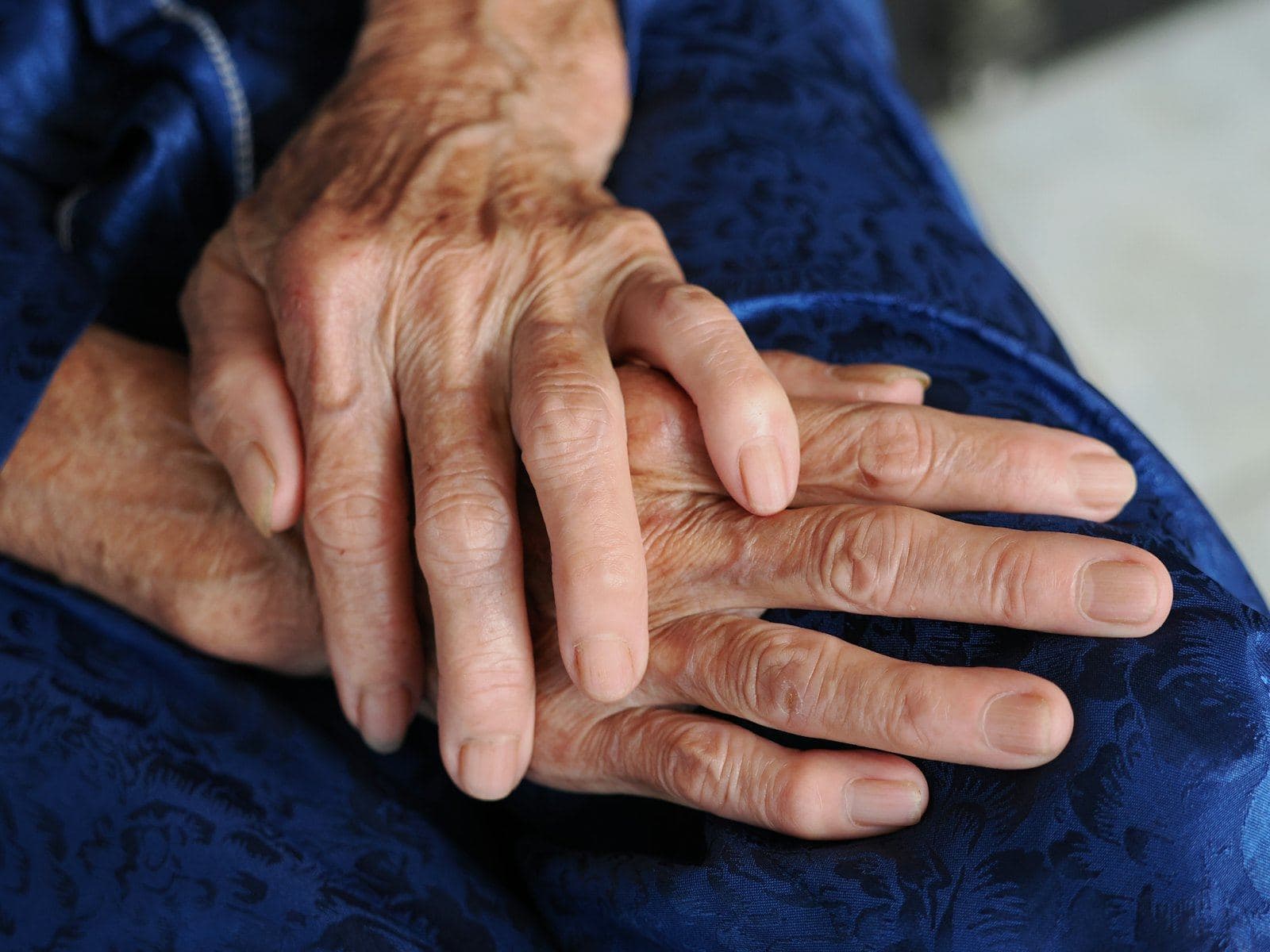 An older person's hands resting together