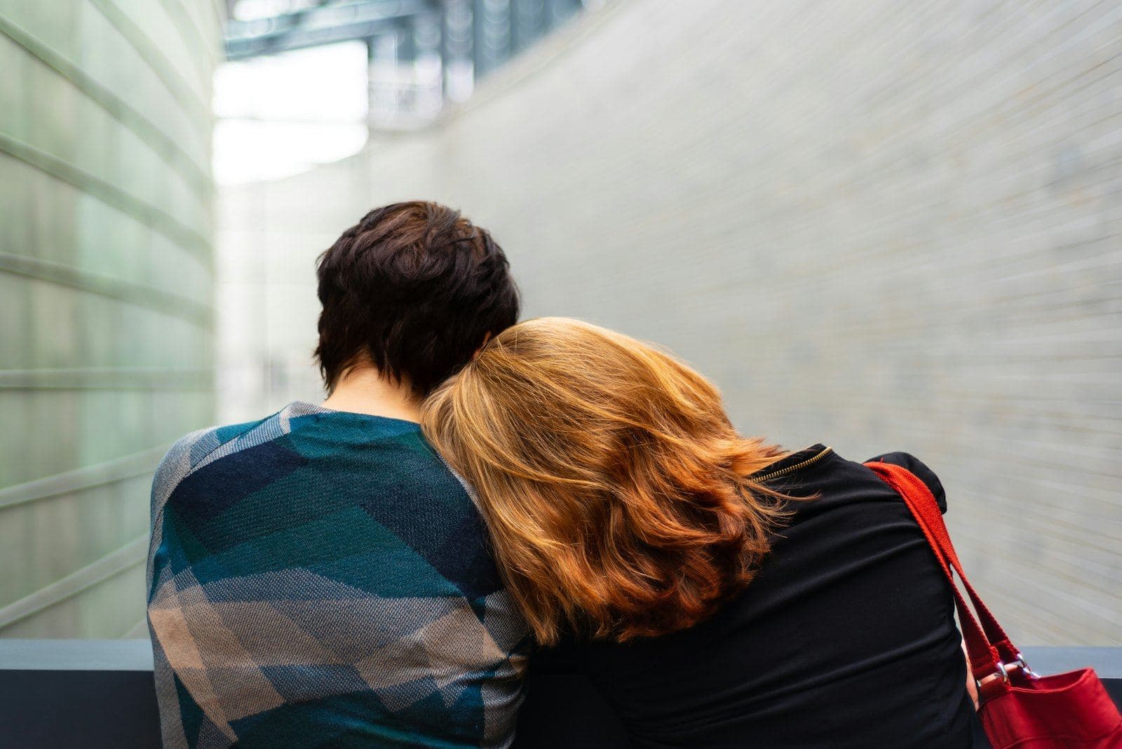 Two people leaning on each other for comfort